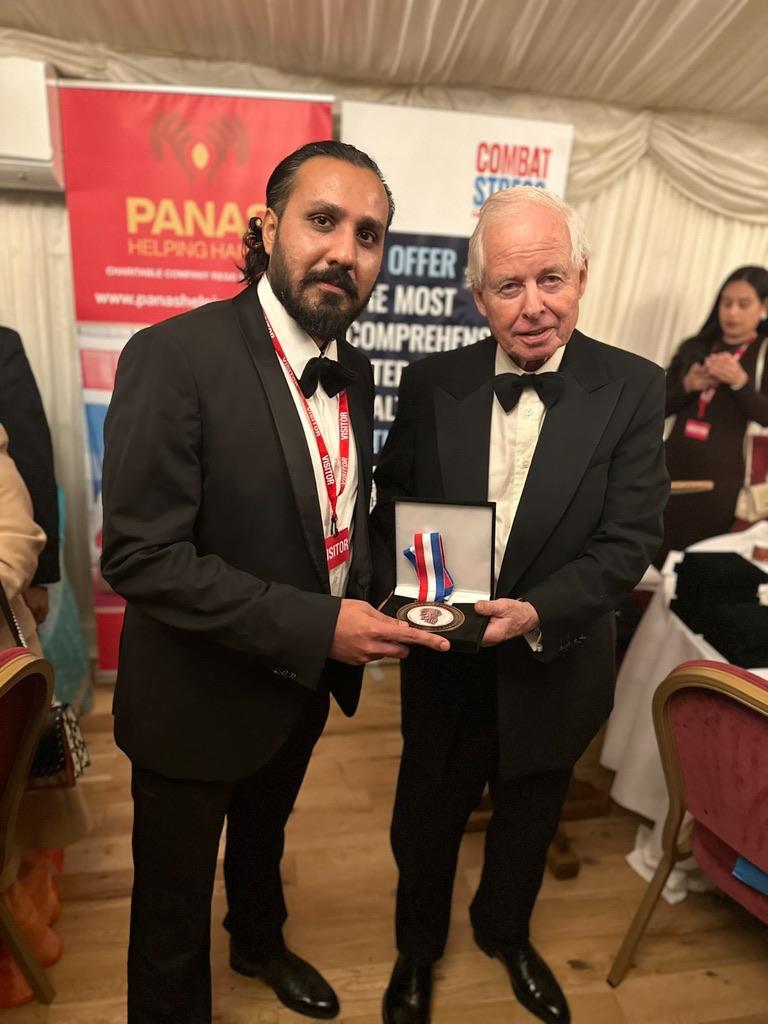 Ahmed Junaid receiving a medal at a ceremony
